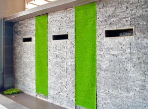 a brick wall with green moss on it at G5 HOTEL AND SERVICED APARTMENT in Johor Bahru