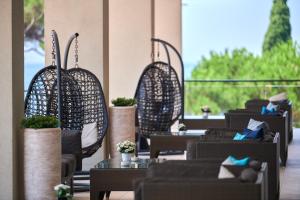 a row of tables and chairs in a restaurant at Hotel Parentium Plava Laguna in Poreč