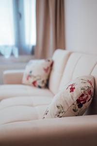 a white couch with two pillows on it at Luxury Apartment in Plaka - Acropolis (Rosemary) in Athens