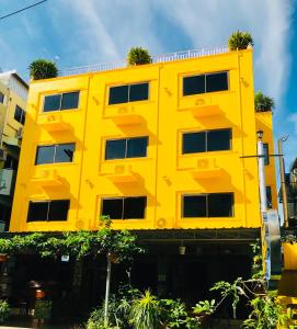 a yellow and blue building with a yellow and blue roof at J Mansion in Ao Nang Beach