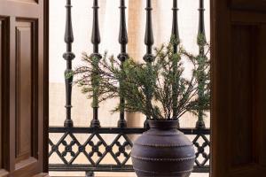 a blue vase with a plant in it next to a fence at Riad Alhambra in Granada