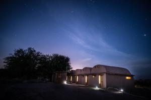 a building with lights on it at night at Planeta Atacama Lodge in San Pedro de Atacama