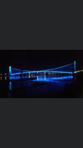 a blue bridge is lit up at night at Studio apartman Ana in Osijek