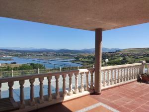 a balcony with a view of the water at VILLA OSTRERA in Suances