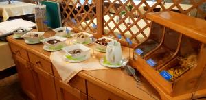 a table with bowls and plates of food on it at Hotel Gasthof Klammstein in Dorfgastein