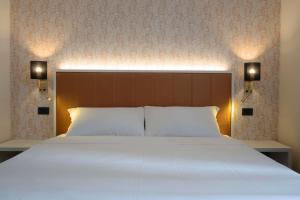 Postel nebo postele na pokoji v ubytování Hotel B&B Fortuna