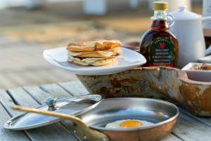 a plate of pancakes and an egg on a table at Princess Resort, Santikos Collection in Agia Paraskevi