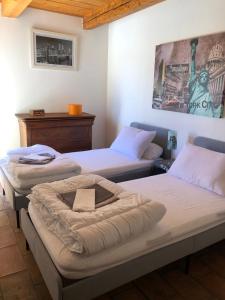 a room with three beds and a painting on the wall at Villa dans le LUBERON à 2 km de LOURMARIN in Lauris +15 photos
