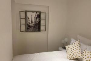 a bedroom with a bed with a picture on the wall at Stylist and cosy appartement in Montparnasse in Paris