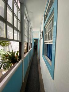 a blue and white walled room with a blue and white window at Pension La Cubana in Santa Cruz de la Palma