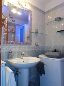 a bathroom with a sink and a mirror at Luxury Domus in Rome +50 photos
