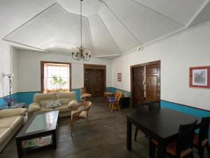 a living room filled with furniture and a large window at Pension La Cubana in Santa Cruz de la Palma