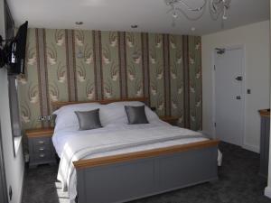 a bedroom with a bed in a room with wallpaper at The View on the terrace in Weymouth