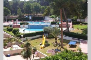 a swimming pool with a slide in a park at 2BD-Piscina-Playa-Port Aventura2 in Salou