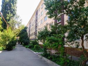 an empty street in front of a building at Tri stolitsy Apartment in Krasnodar
