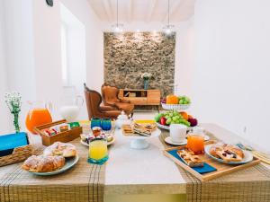a breakfast table with breakfast foods and orange juice at Sweet Country Home - Casa LuMePa in Pompei