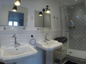 a bathroom with two sinks and a shower at VILLA LES OMBREES in Arcachon