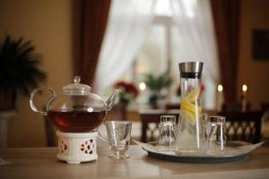 a tea kettle and glasses on a table at Villa Hierschel Droyßig in Droyßig