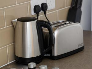 a coffee pot and toaster on a kitchen counter at Vine Studio in Leeds