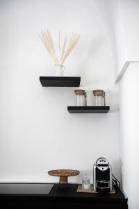 a room with a table and a toaster and shelves at Arya Nobile Dimora in Carovigno
