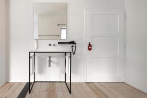 a kitchen with a table in front of a door at Casa al Sole in Ortisei