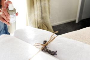 a person is holding a bottle of paint on a bed at Arya Nobile Dimora in Carovigno