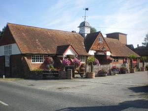 a building with a clock tower on top of it at The Walhampton Arms in Lymington