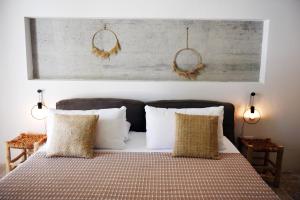 a bedroom with a bed with pillows and a picture on the wall at Arya Nobile Dimora in Carovigno