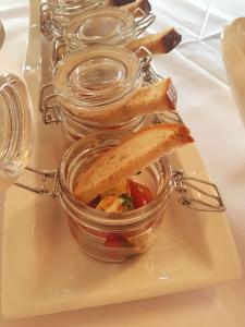 a plate with two jars of food on a table at Hotel-Weinhaus Stettler in Lieser