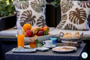 a breakfast table with a bowl of fruit and orange juice at Douro Village in Vila Real