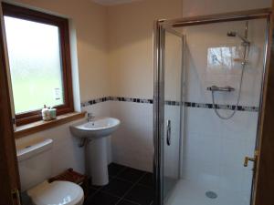 a bathroom with a shower and a toilet and a sink at Wester Muirhouse in Linlithgow