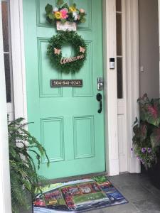 a green door with a welcome sign on it at WG Creole House 1850 in New Orleans