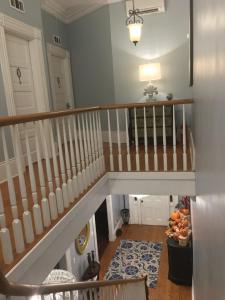 a staircase in a living room with a stair case at WG Creole House 1850 in New Orleans