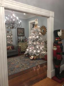 a white christmas tree in a living room with a christmas at WG Creole House 1850 in New Orleans