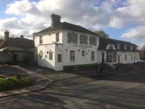 a white building on the corner of a street at The Wheatsheaf Inn in Cuckfield