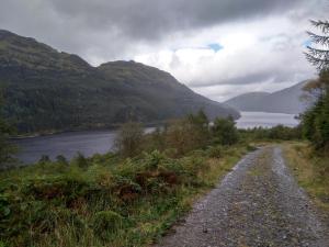 a dirt road next to a body of water at Whistlefield Inn in Dunoon