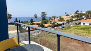 a balcony with a view of the ocean at Madeira Mero Apartment in Caniço