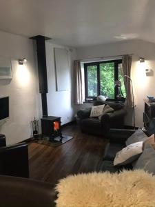 a living room with a couch and a fire place at The Old Piggeries in Gulval