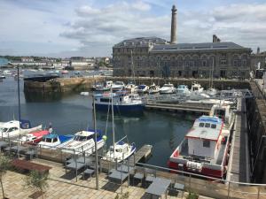 Une bande de bateaux amarrés dans un port de plaisance avec un bâtiment dans l'établissement Royal William Yard Apartments, à Plymouth