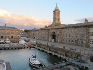 a boat in the water in front of a building at Royal William Yard Apartments in Plymouth