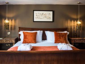 a bedroom with a large bed with two pillows at Woolmarket House in Chipping Campden