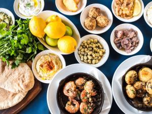 a table with plates of food and bowls of food at Woolmarket House in Chipping Campden