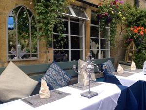 a group of tables with blue and white tablecloths at Woolmarket House in Chipping Campden