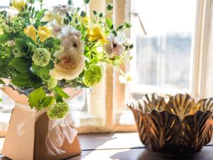 a vase filled with flowers sitting on a table at Woolmarket House in Chipping Campden