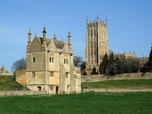 an old castle with a clock tower in the background at Woolmarket House in Chipping Campden