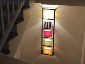 a light on the side of a staircase with a shelf at Zeit in Eckernförde in Eckernförde