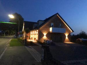 a house with lights on the side of it at night at Zur Alten Schmiede in Straelen