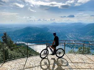 a man riding a bike on top of a mountain at Bellavista Boutique Hotel in Brunate