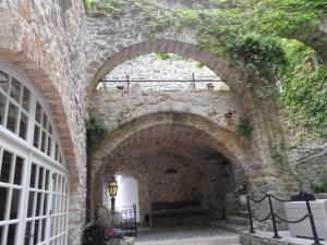 an archway in a stone building with ivy at Châteauzen in Madières