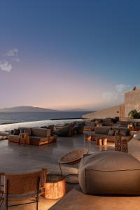 a resort with chairs and tables on the beach at Andronis Arcadia Hotel in Oia